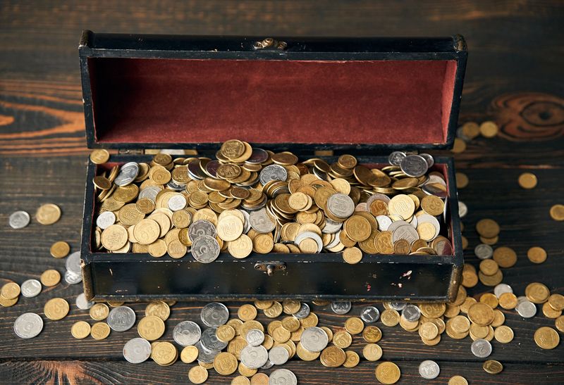 A wooden chest of mixed gold and silver coins, like the world coin collections Denver families bring in