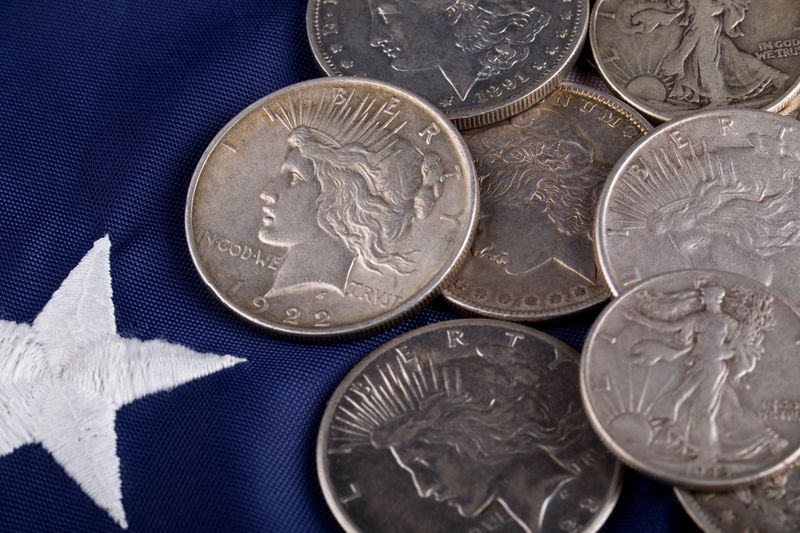 Morgan and Peace silver dollars resting on a flag star at a Denver silver dollar appointment